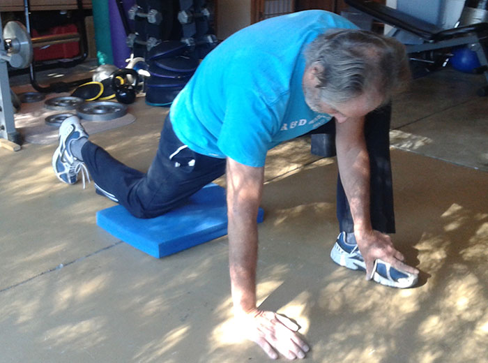 Ed W doing a hip flexor stretch on the ground.
